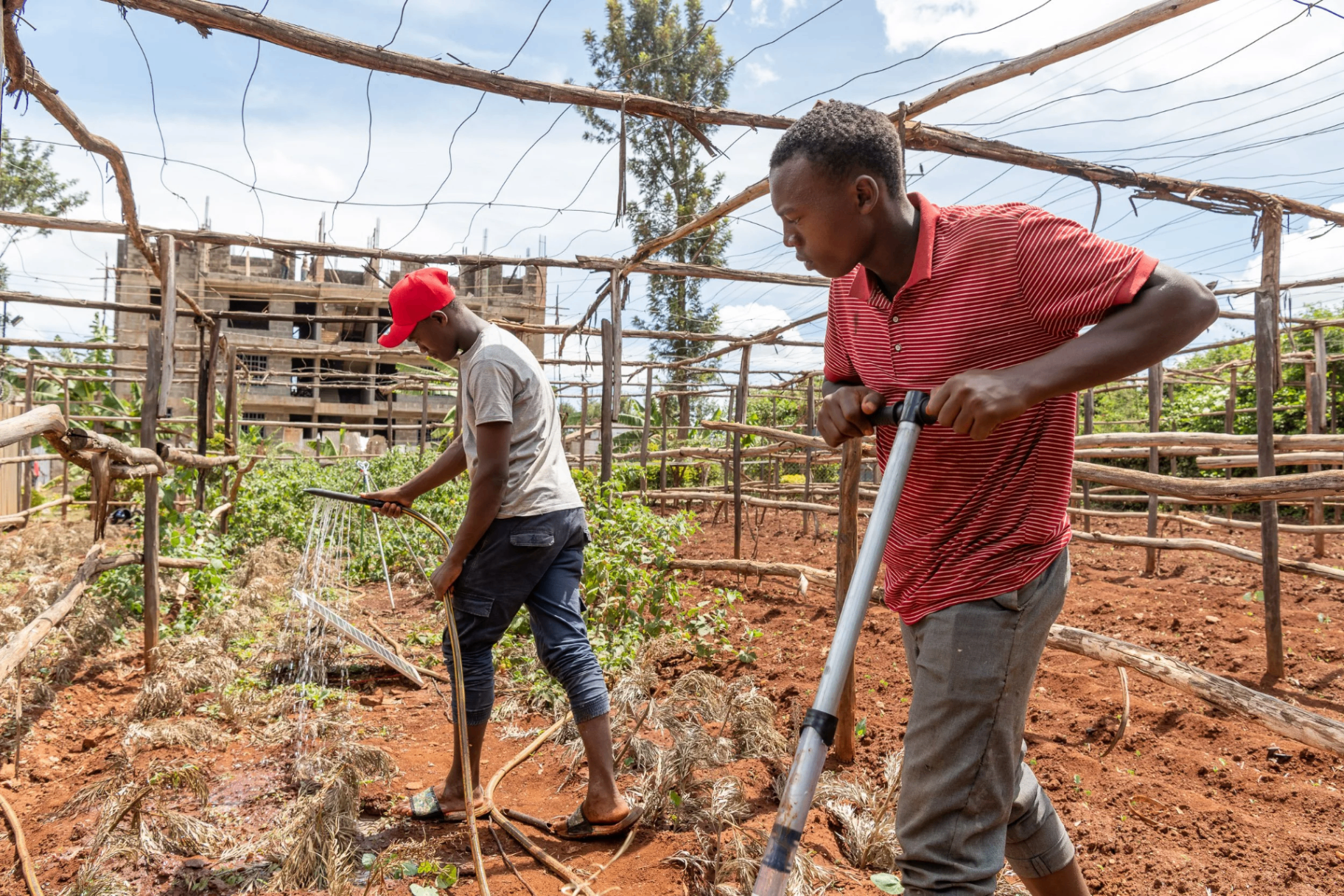 Young farmer pumping water with a MoneyMaker pump